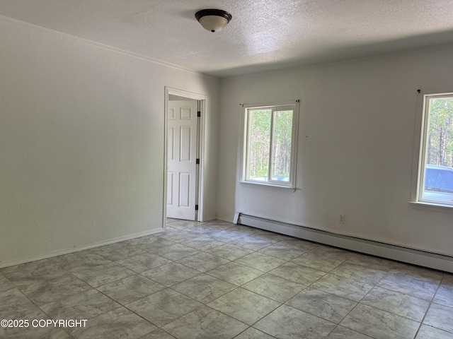 3140 N Brocton Ave, Wasilla, AK 99654 - spare room with a textured ceiling, a baseboard heating unit, a textured wall, and baseboards