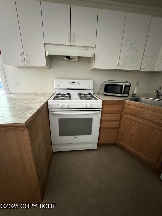 3140 N Brocton Ave, Wasilla, AK 99654 - kitchen featuring a sink, light countertops, gas range gas stove, stainless steel microwave, and under cabinet range hood