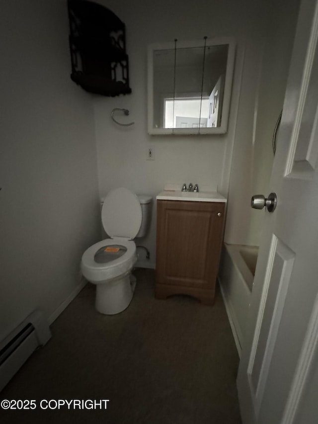 3140 N Brocton Ave, Wasilla, AK 99654 - full bathroom with vanity, toilet, a washtub, baseboards, and a baseboard heating unit