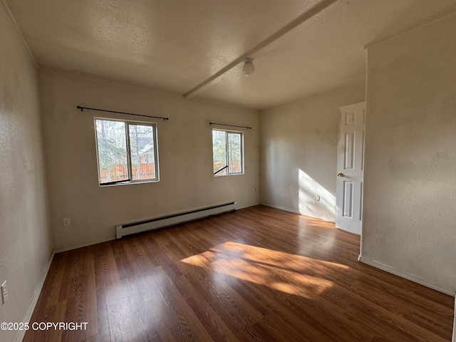 3140 N Brocton Ave, Wasilla, AK 99654 - spare room featuring a textured ceiling, wood finished floors, baseboards, and a baseboard heating unit