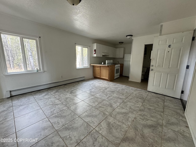 3140 N Brocton Ave, Wasilla, AK 99654 - unfurnished living room featuring a textured ceiling and a baseboard heating unit