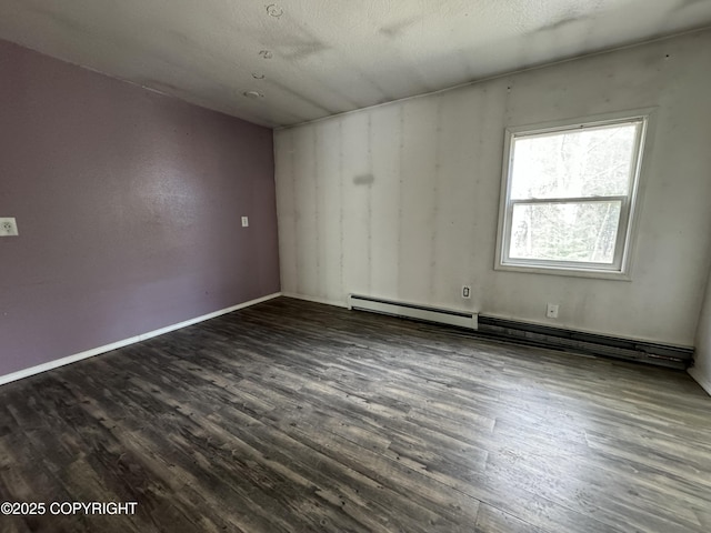 3140 N Brocton Ave, Wasilla, AK 99654 - unfurnished room featuring a baseboard radiator, baseboards, and dark wood finished floors