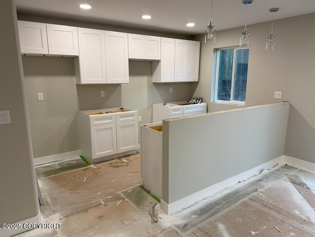 kitchen featuring recessed lighting, baseboards, white cabinets, and hanging light fixtures