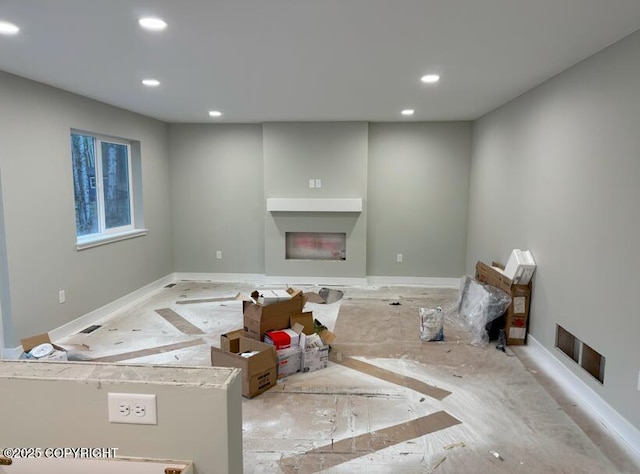 unfurnished living room featuring recessed lighting, baseboards, visible vents, and a fireplace