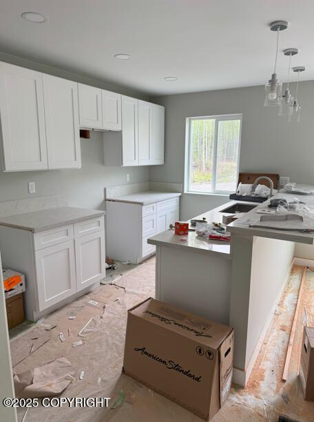 7380 S Brimstone Dr, Wasilla, AK 99623 - kitchen with white cabinetry, decorative light fixtures, recessed lighting, and light countertops