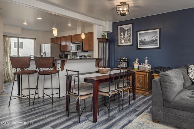 dining space with recessed lighting and dark wood-style floors