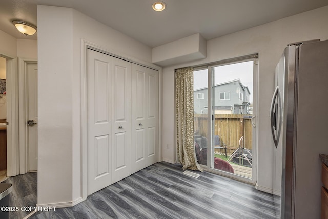 interior space with dark wood-style flooring, baseboards, visible vents, and recessed lighting