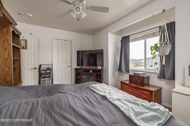 bedroom featuring baseboards and ceiling fan