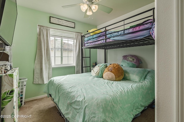 carpeted bedroom featuring ceiling fan and baseboards