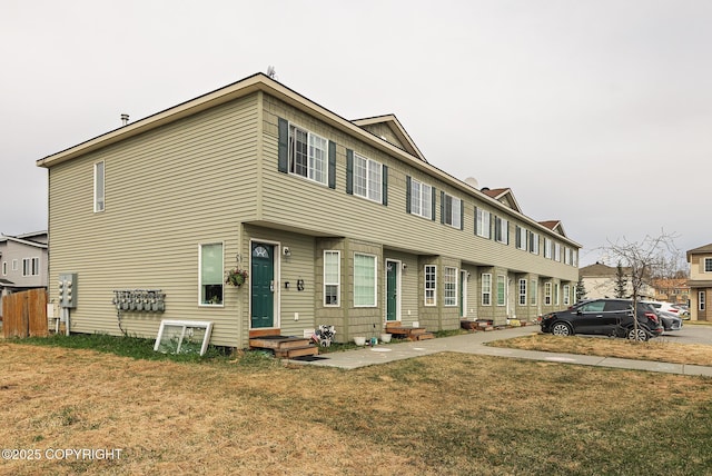 view of property featuring a front lawn