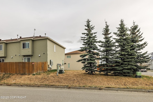 view of home's exterior with fence and central AC