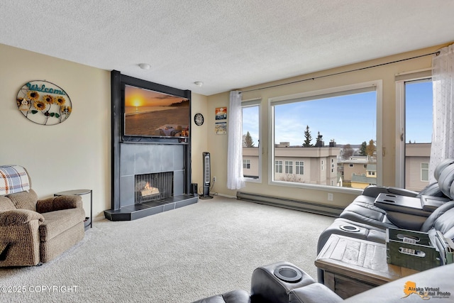 living area featuring a textured ceiling, baseboard heating, a fireplace, baseboards, and carpet