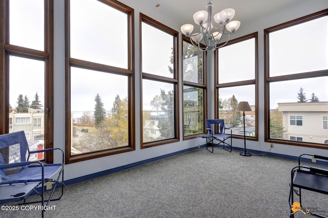 sunroom featuring a notable chandelier