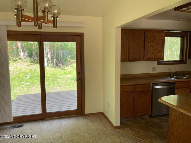 5875 E Alder Cir, Wasilla, AK 99654 - kitchen featuring brown cabinets, an inviting chandelier, a sink, stainless steel dishwasher, and visible vents