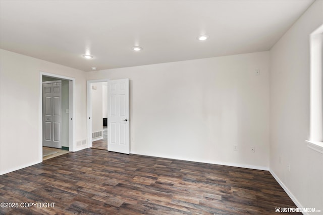 unfurnished bedroom with baseboards, visible vents, recessed lighting, and wood finished floors