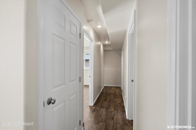 hall with baseboards, recessed lighting, and dark wood-type flooring