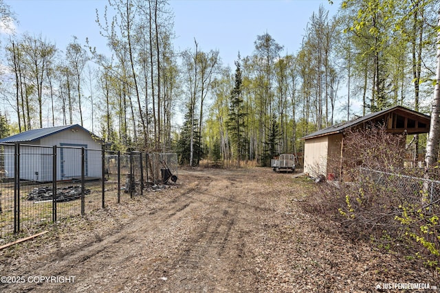 exterior space featuring fence and an outbuilding