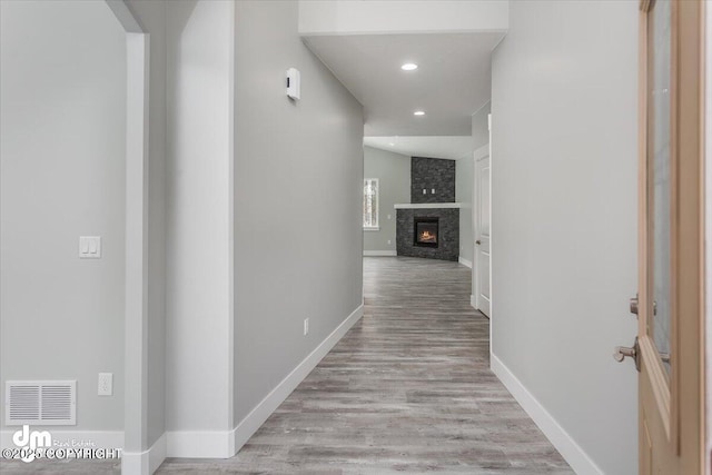 hall featuring visible vents, recessed lighting, light wood finished floors, and baseboards