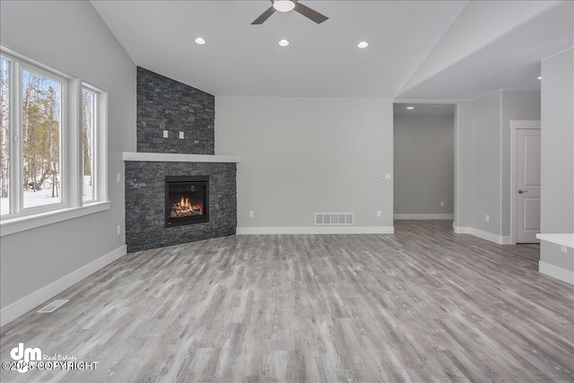 unfurnished living room with plenty of natural light, visible vents, a ceiling fan, and lofted ceiling