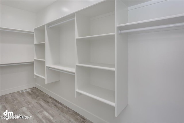 spacious closet with visible vents and wood finished floors