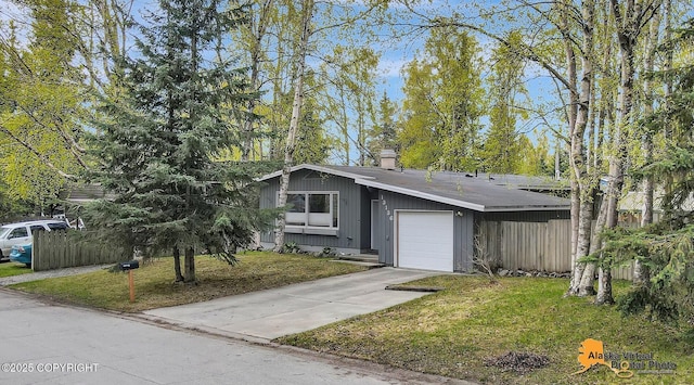 view of front of house with a front lawn, an attached garage, driveway, and a chimney