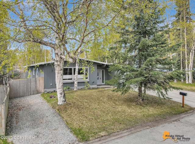 mid-century inspired home with driveway and board and batten siding