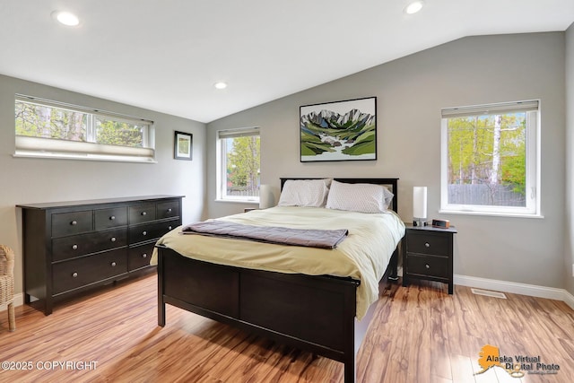 bedroom with lofted ceiling, light wood finished floors, baseboards, and recessed lighting