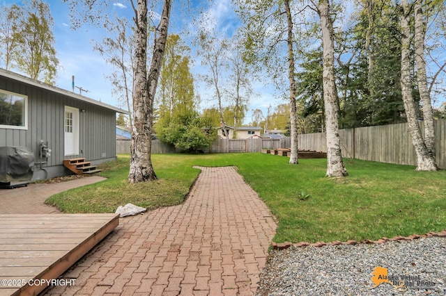 view of yard featuring entry steps and a wooden deck