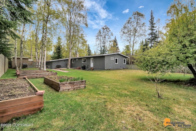 view of yard featuring a vegetable garden and entry steps