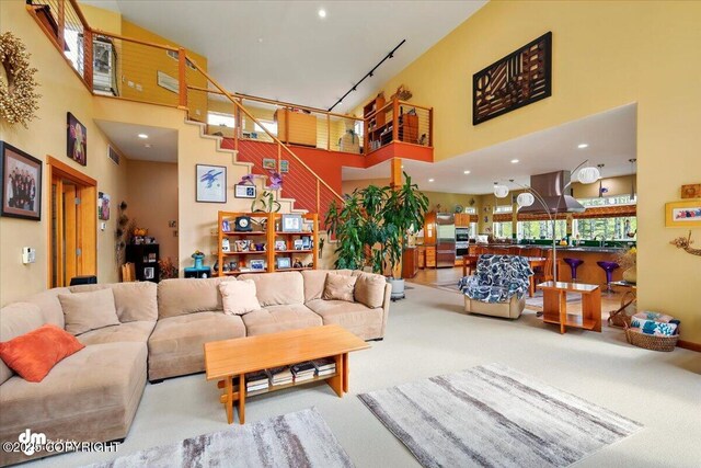 8115 N Highlander, Wasilla, AK 99654 - living area featuring a towering ceiling, carpet flooring, stairs, and recessed lighting