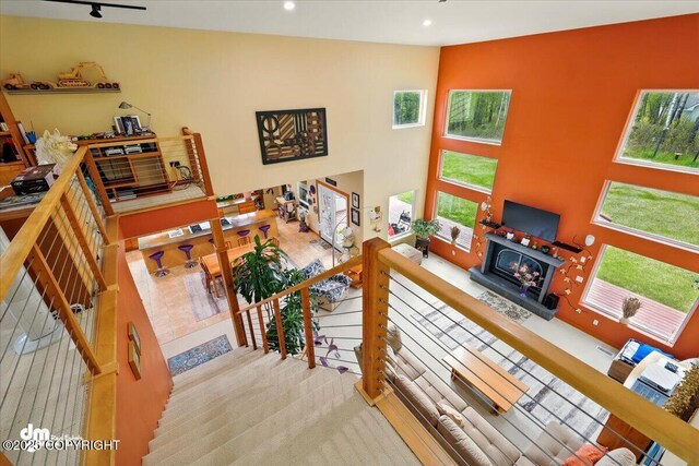 8115 N Highlander, Wasilla, AK 99654 - living area with a warm lit fireplace, recessed lighting, and carpet floors