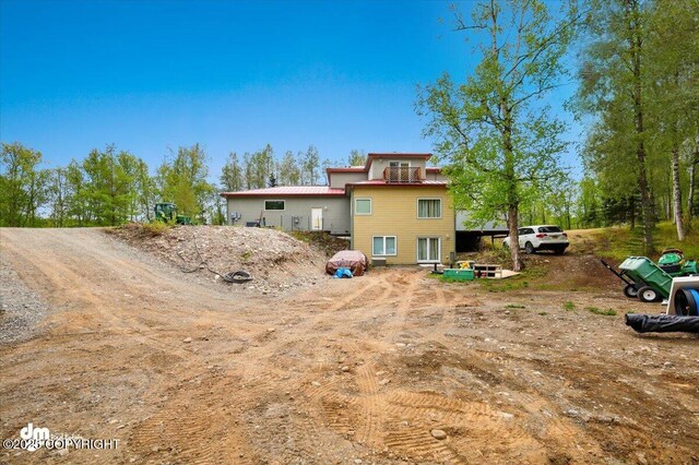8115 N Highlander, Wasilla, AK 99654 - back of house featuring a balcony