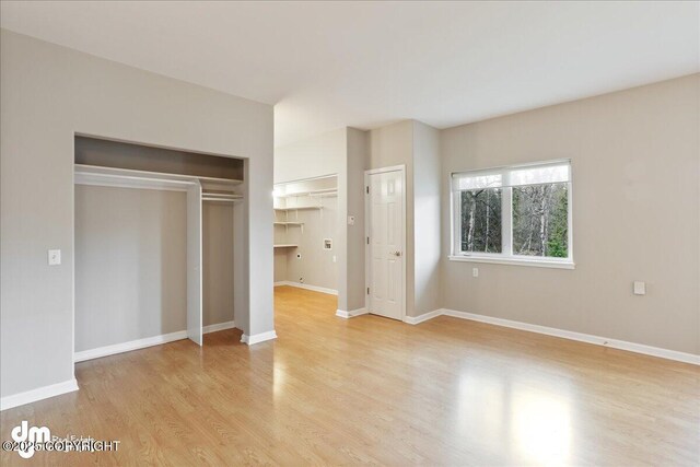 unfurnished bedroom featuring light wood-type flooring and baseboards