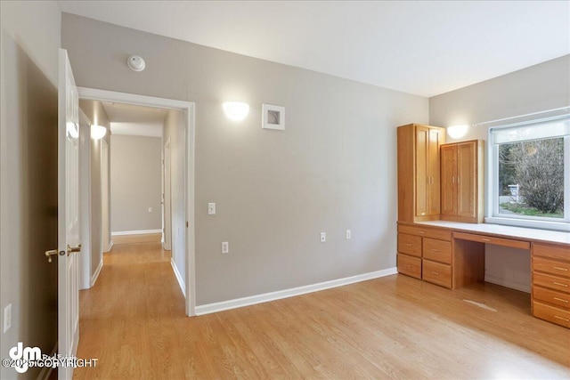 unfurnished bedroom featuring light wood finished floors and baseboards