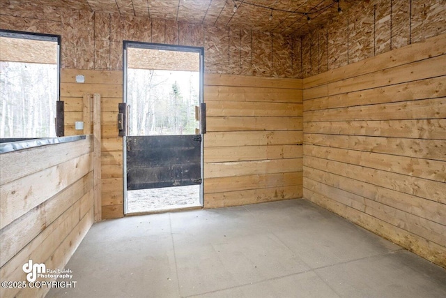 unfurnished room with wood walls