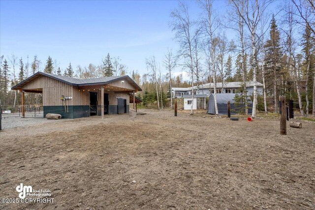 view of side of property featuring an outbuilding and an exterior structure
