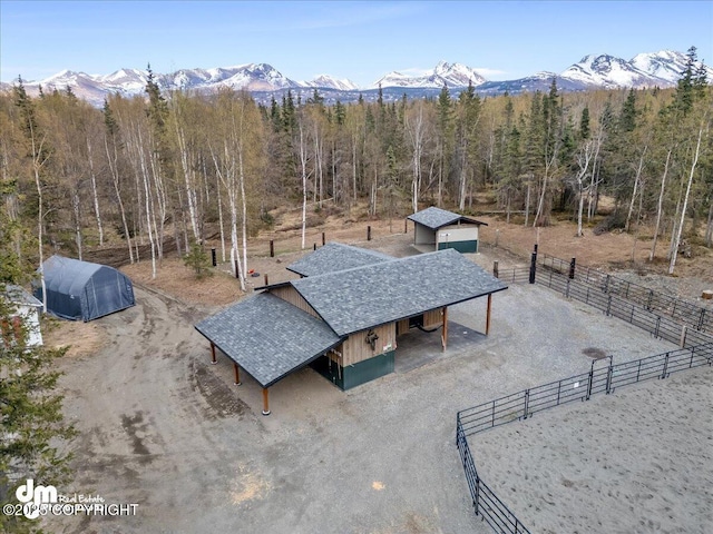 view from above of property featuring mountains and a forest