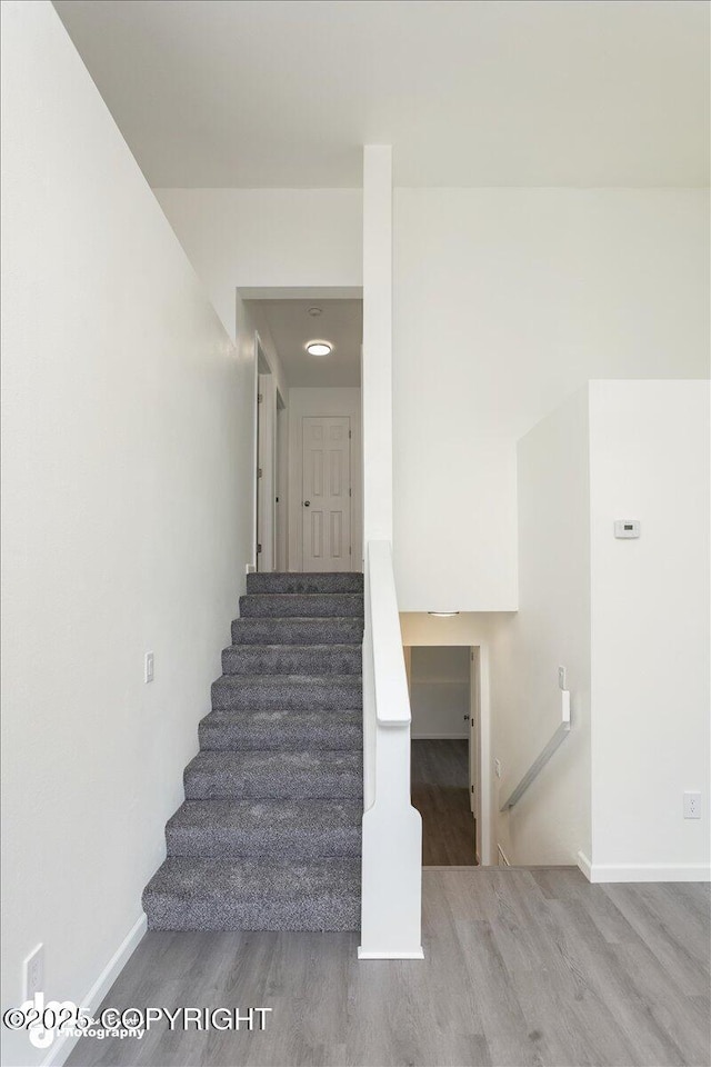 stairs with baseboards and wood finished floors