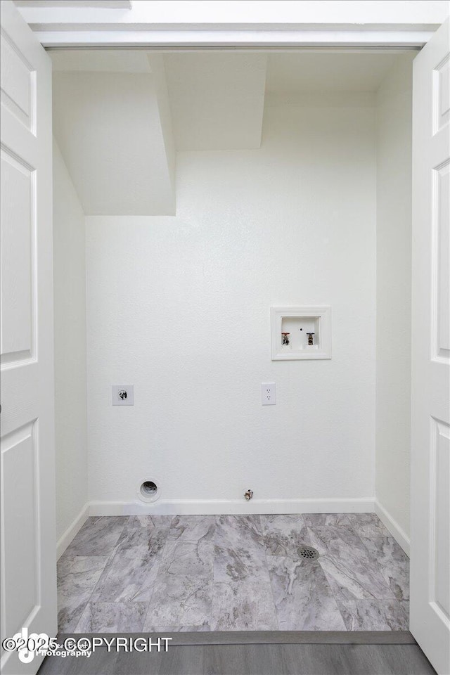 washroom with hookup for an electric dryer, washer hookup, hookup for a gas dryer, and baseboards