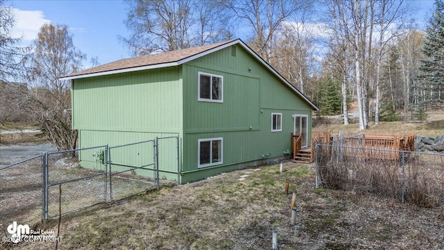 view of side of property featuring a gate and fence