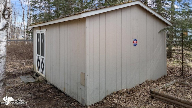 view of shed with fence