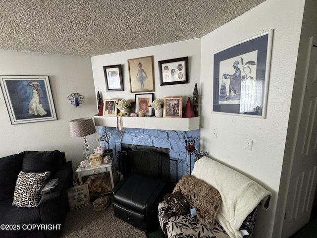 sitting room featuring a textured ceiling and a fireplace