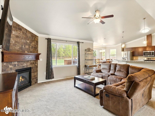 living room featuring light carpet, crown molding, a ceiling fan, lofted ceiling, and a large fireplace