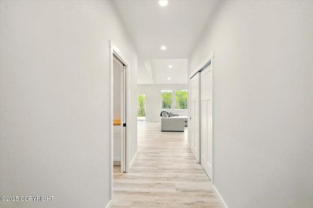 hall featuring recessed lighting, light wood finished floors, and baseboards