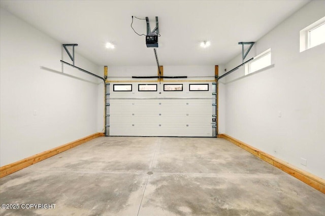 garage featuring baseboards and a garage door opener
