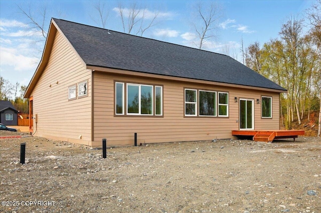 view of front of property with roof with shingles and a wooden deck