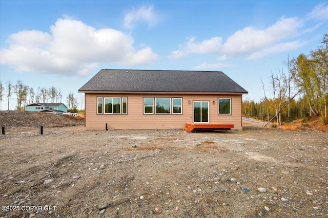 rear view of property featuring a deck