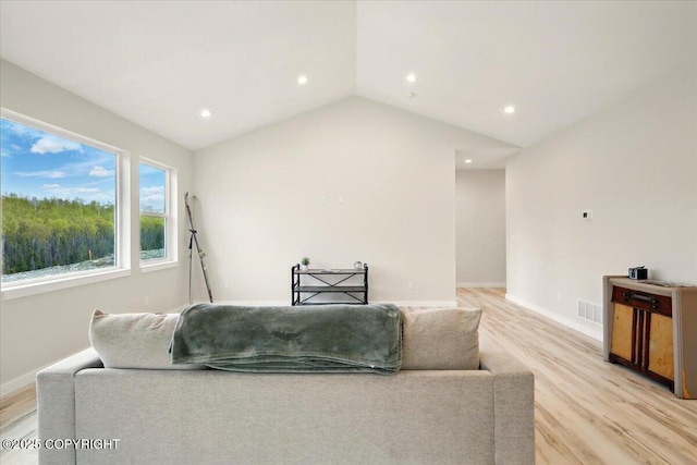 living room with recessed lighting, baseboards, visible vents, and light wood finished floors
