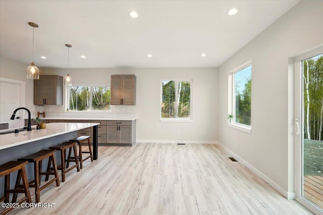 kitchen with light countertops, recessed lighting, and light wood-type flooring