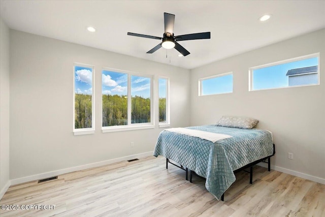 bedroom featuring baseboards, recessed lighting, wood finished floors, and visible vents